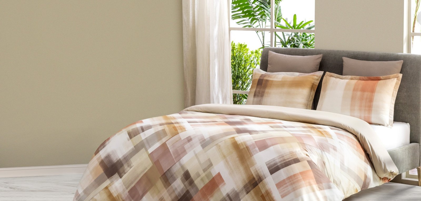 A cozy bed with a white and brown comforter, inviting you to relax and unwind.