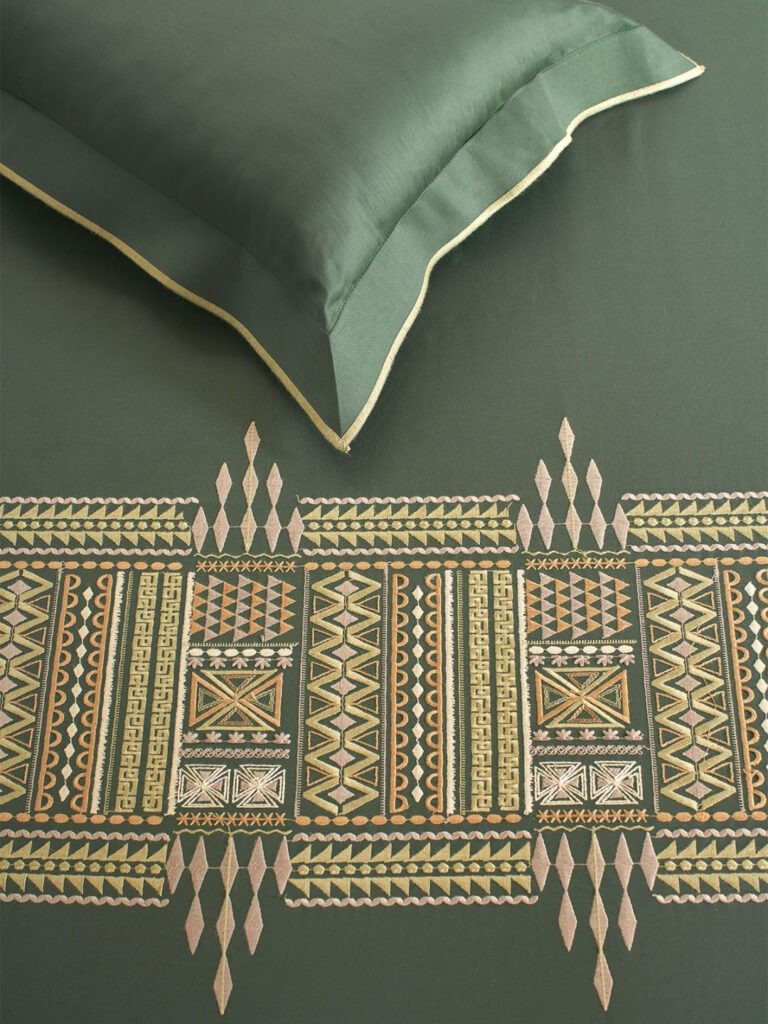 Trident Bedsheets: Green bed with elegant green and gold pattern, adding a touch of luxury.