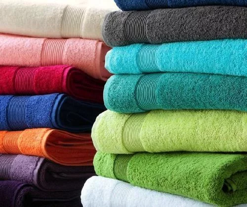 Colorful towels stacked neatly, showcasing a vibrant array of hues.