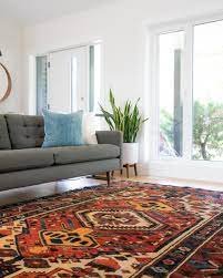 A stylish rug and comfortable couch, create a warm and inviting atmosphere.