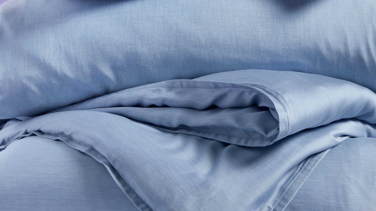 Blue sheet and a soft blue comforter.
