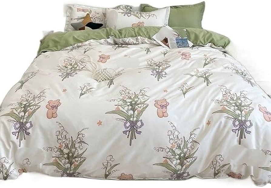 A floral-patterned bed with a green pillow and a comforter.