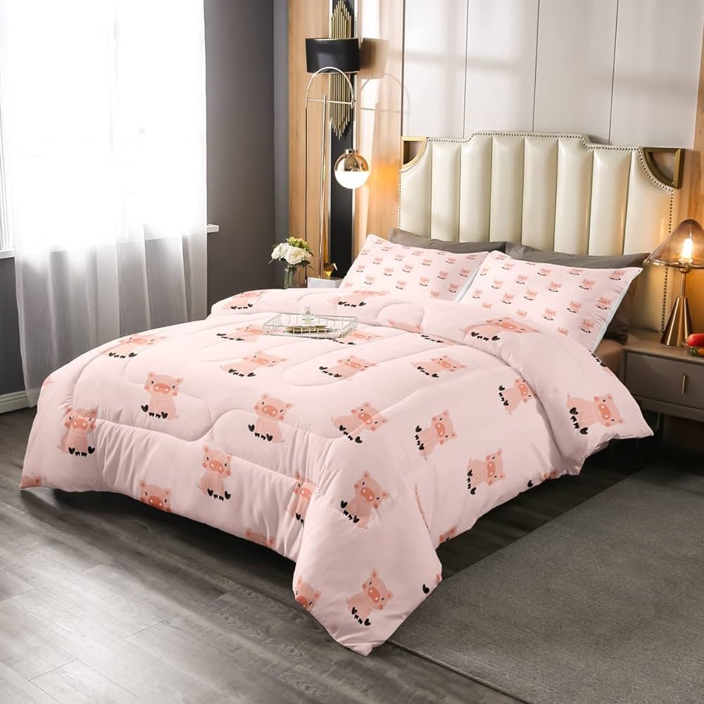 Pink comforter with black and white pig pattern.