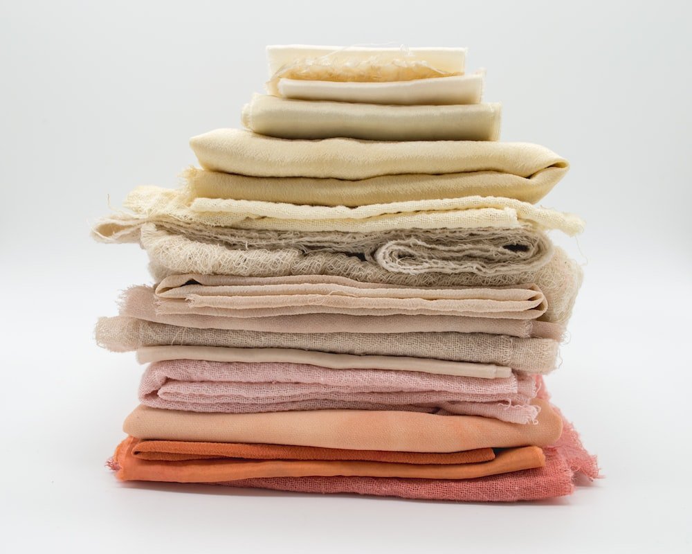 A stack of blankets neatly arranged.