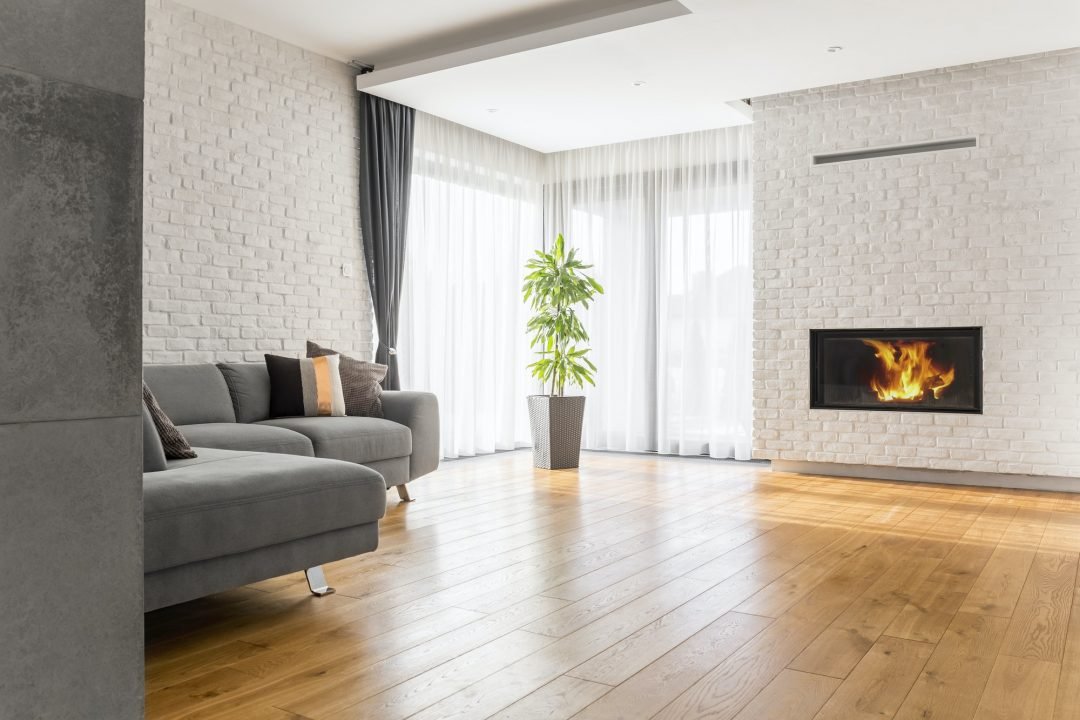 Contemporary living room with fireplace, wooden floor, AARTEX sofa fabrics, and white brick wallpapers.