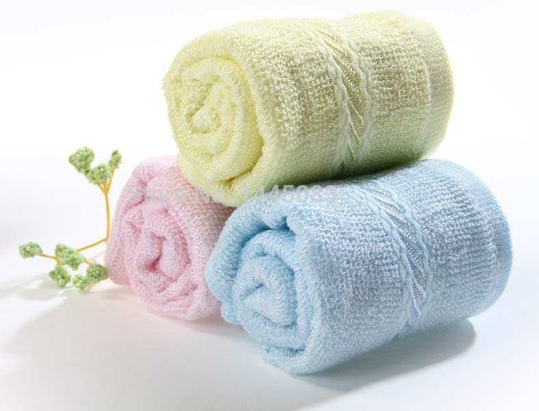 Three folded towels: one blue, one green, and one yellow, each with a different size.