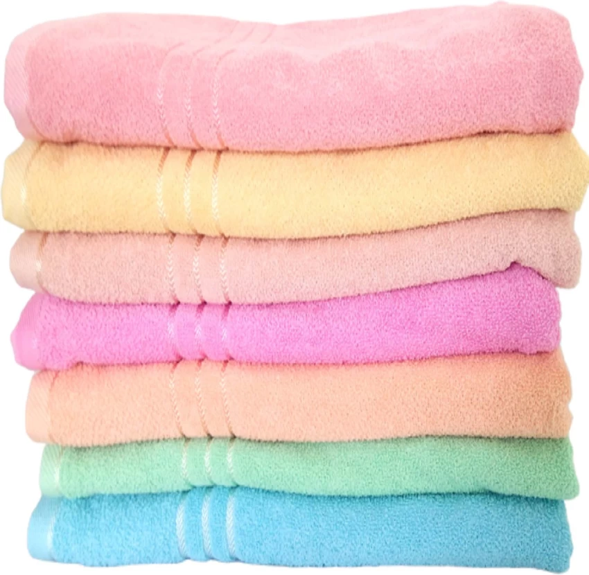 Colorful towels neatly stacked, adding vibrancy and style to any bathroom.