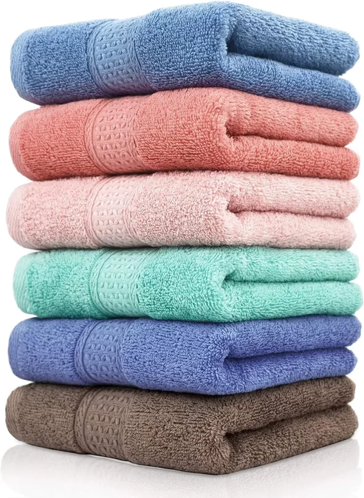 A stack of four colorful towels neatly arranged on top of each other.
